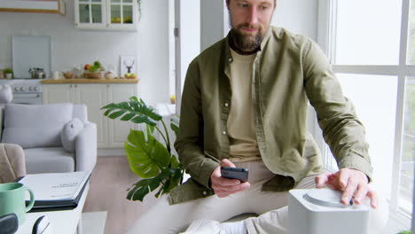 man sitting on the windowsill