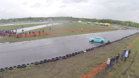 drifting car race on a wet track with spectators