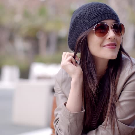 Happy-relaxed-trendy-woman-sitting-daydreaming