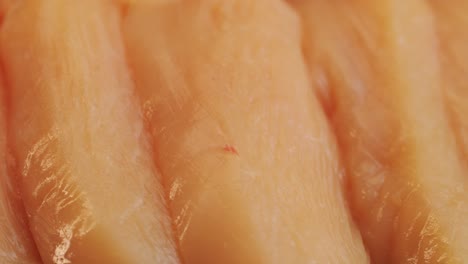 cutting with knife raw chicken meat on desk close-up. preparing raw food for cooking. grilled chicken, duck, turkey kebab with vegetables.