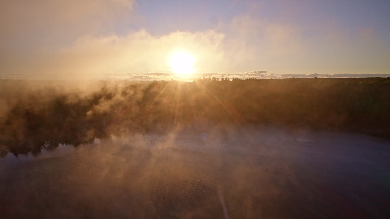 Aerial clip of a river meandering through brilliant autumn forest