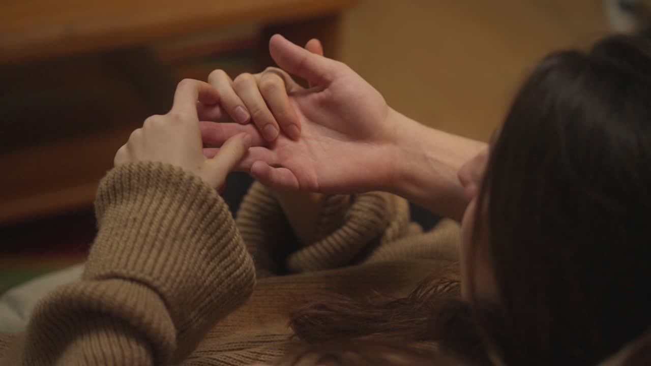 Close-up of a Couple Holding Hands in a Tender Moment
