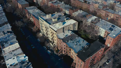 incredible aerial drone shot of brooklyn new york apartments and tenement buildings, as pedestrians and cars pass by