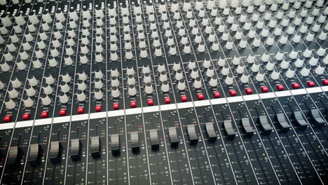 Mixing-console-also-called-audio-mixer,-sound-board,-mixing-deck-or-mixer.--Image-or-animation-of-audio-console-could-be-used-for-any-theme-related-to-music-recording-and-mixing.-Loopable.-HD