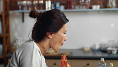 Pretty-brunette-taking-slice-of-pizza