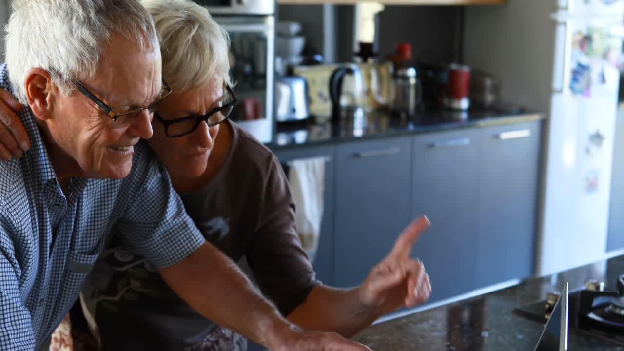 Senior couple making video call on laptop 4k