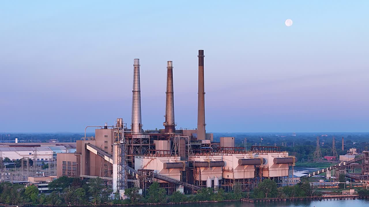 DTE River Rouge Power Plant with moon above during early evening in Michigan, USA