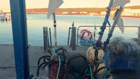 Colorful-buoys,-secured-at-the-coastal-dock-and-embellished-with-markings,-embody-the-vibrant-essence-of-maritime-life