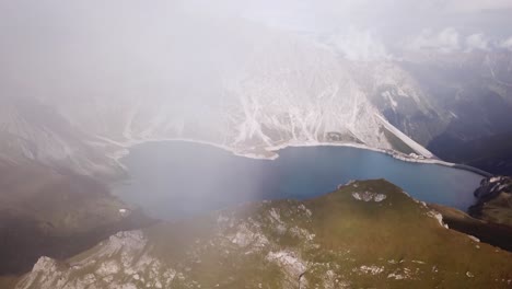 vertical drone flight in fog alps lünersee lake in austria vorarlberg