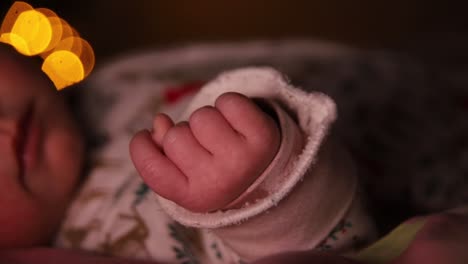 newborn child lying and breathing in the dark