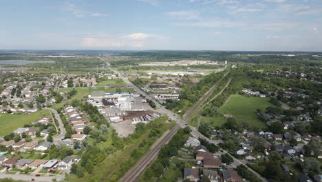 Aerial-pullback-from-large-x-shaped-four-way-intersection-in-canada,-blue-sky-day