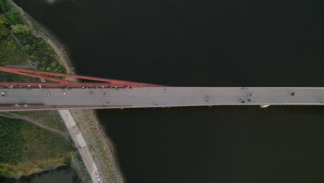 modern pedestrian bridge over vistula river, aerial top down view