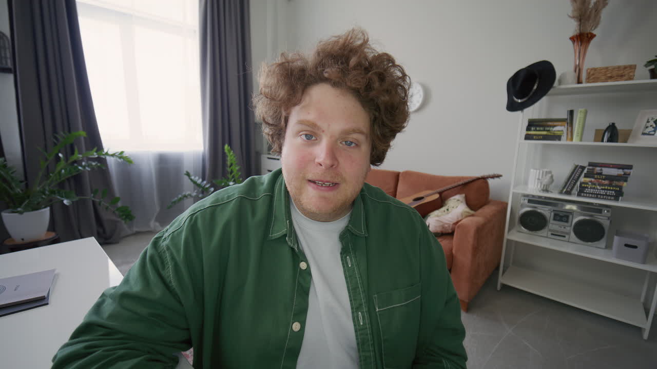 Man Waving andвЂ‹ Speaking on Camera during Live Stream or Vlog Recording