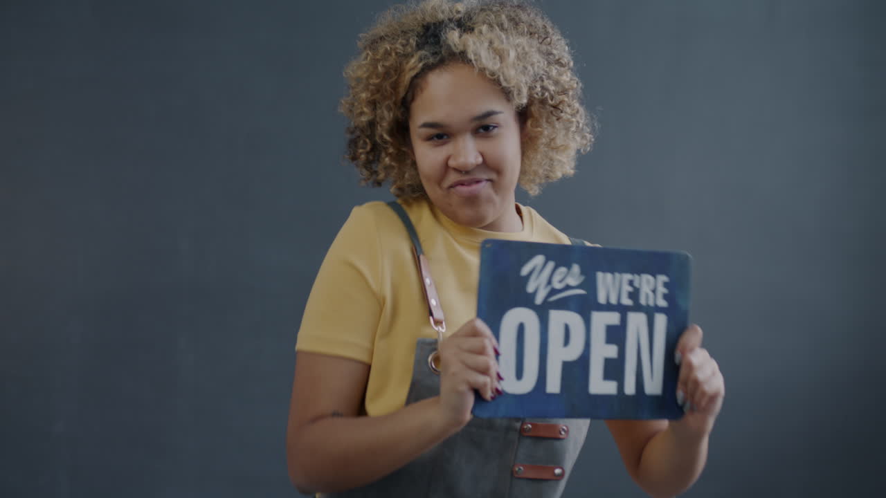 Woman Holding Open Sign