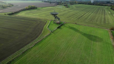 mullard mrao radio telescope dish on cambridge farmland with long sunset shadow aerial view