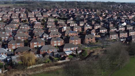 typical suburban village residential essex neighbourhood property rooftops aerial view slow descend pan right
