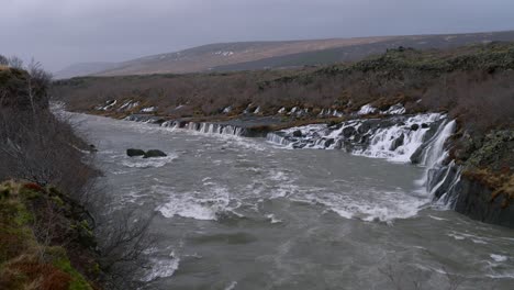 Waterfall-Cascading-From-Lava-Fields-To-Hvita-River