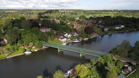 Bourne-End-railway-and-footbridge-town-in-background-sunny-day-UK-Buckinghamshire-Aerial-footage-4K