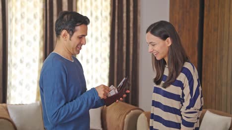 happy indian wife asking husband for shopping money