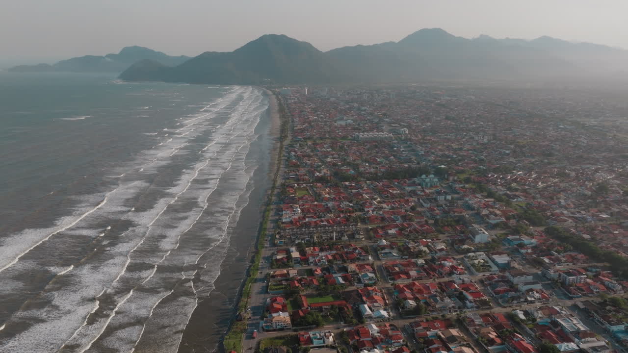 Aerial View of Coastal City with Beach and Mountains