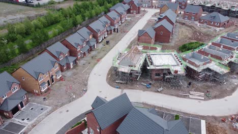 modern unfinished british scaffolding framework housing construction site survey project aerial view