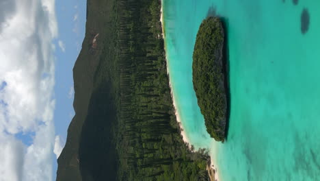 sacred rock islet in kanumera bay on the isle of pines - aerial in vertical orientation