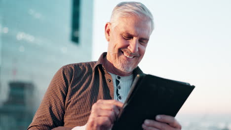 senior businessman using tablet in urban setting