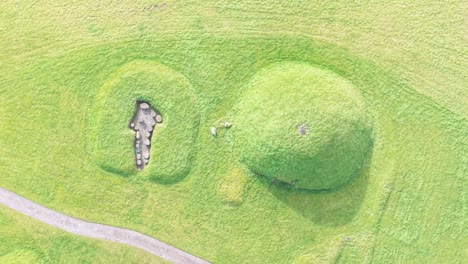 knowth tombs covered in green grass in county meath, ireland. - aerial shot