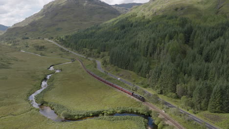 jacobite express aerial track towards glenfinnan station along the river fae