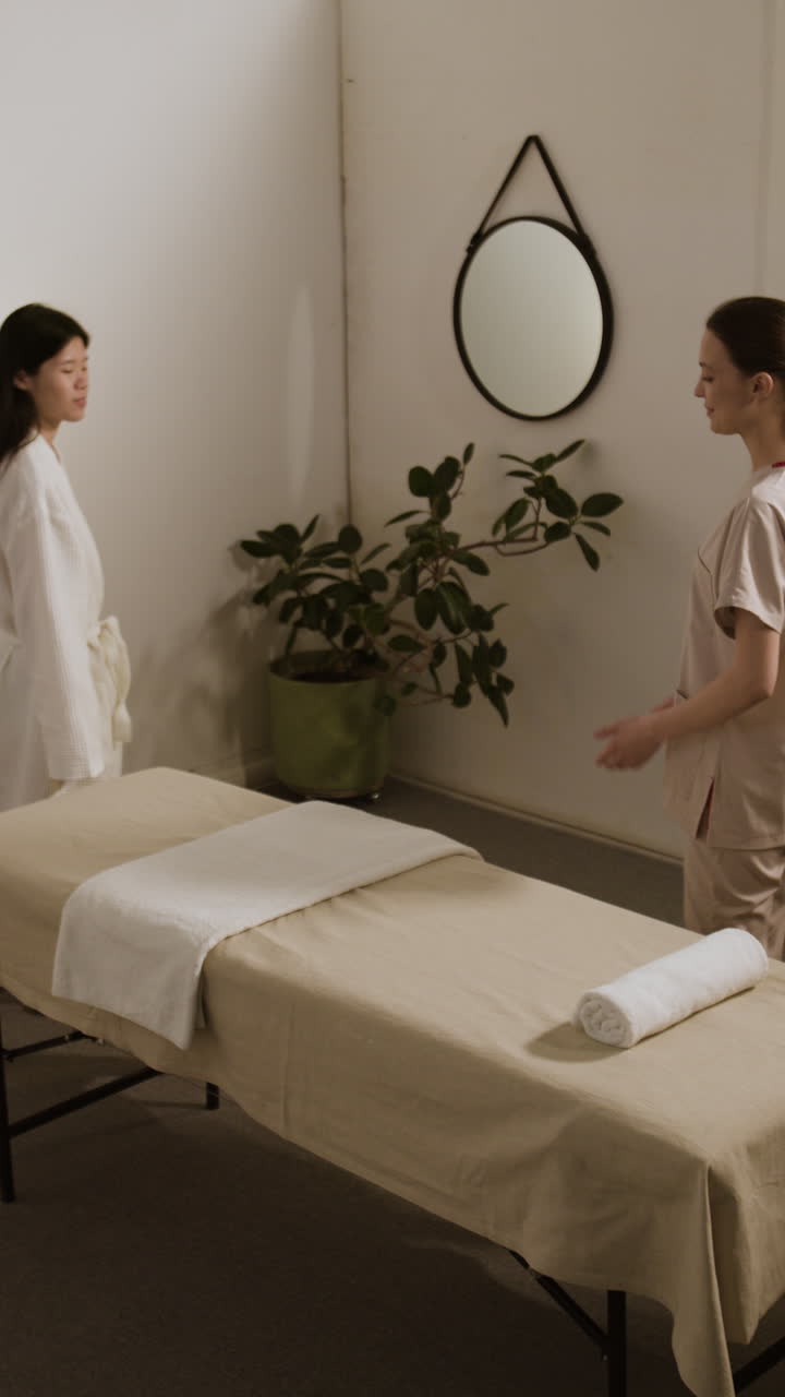 A spa therapist preparing for a client's massage session