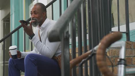 African-American-man-drinking-a-coffee-and-using-his-phone