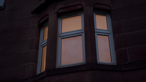 red brick house windows closeup, exterior at night