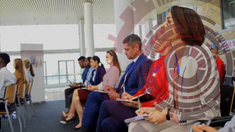 In conference, business professionals taking notes with digital data animation overlay