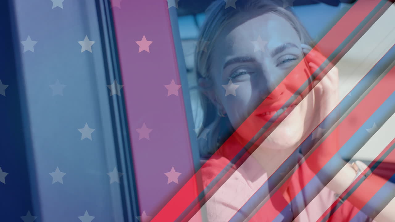 Animation of flag of usa over smiling caucasian woman in car on beach
