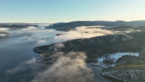 Sunrise-Drone-Aerial-Shot-Flying-Over-snowy-landscape-in-Norway