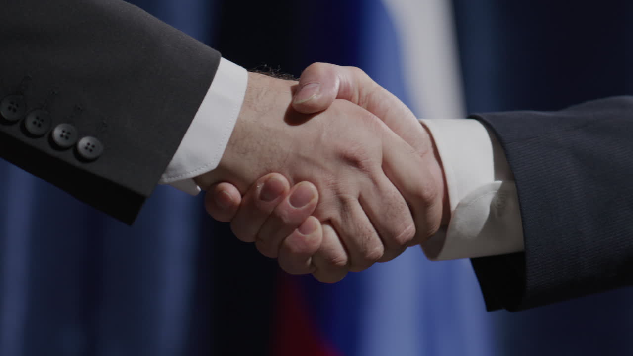 Diplomats Shaking Hands against Russian Flag at Political Press Conference