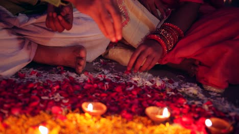 couple celebrate a colorful diwali rangoli- red pink orange green