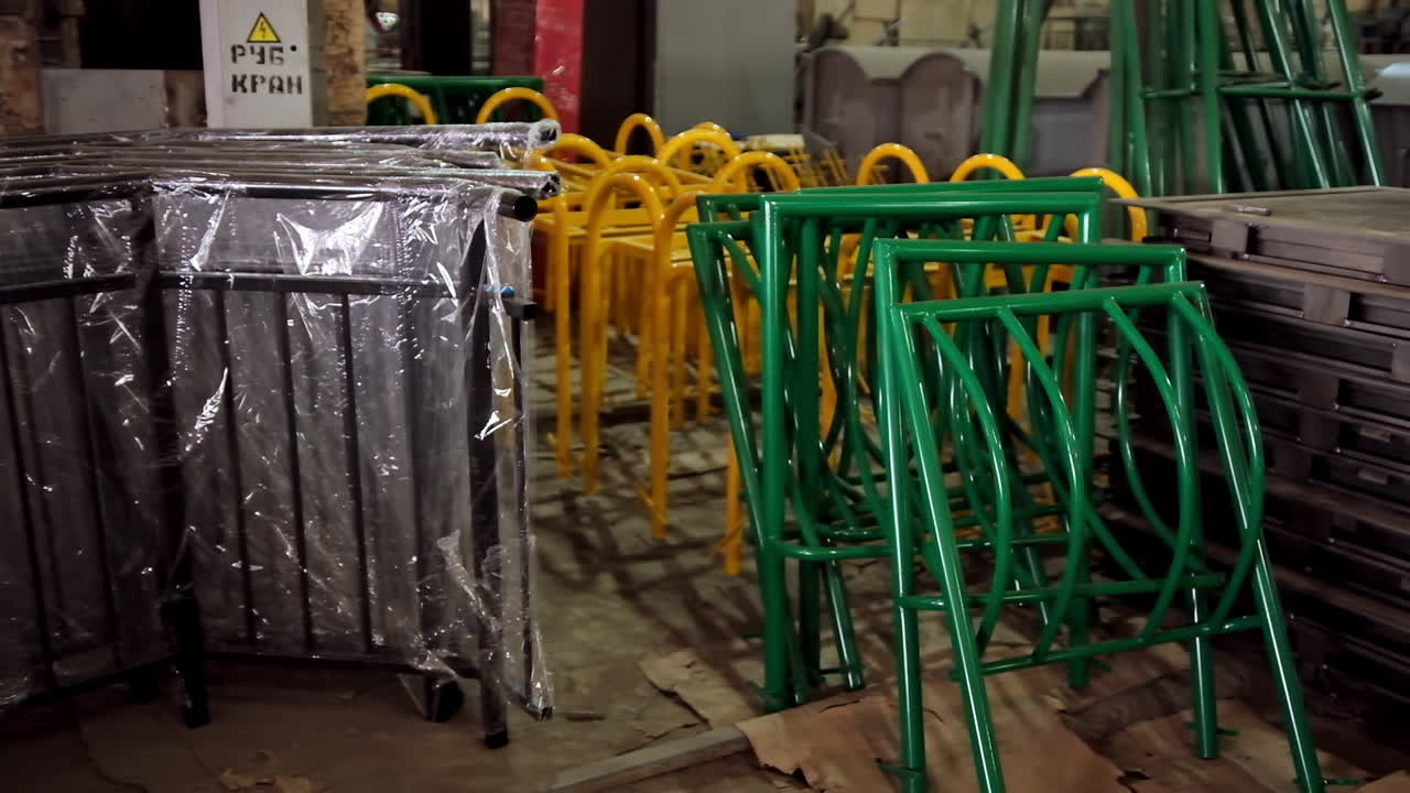 Metal construction parts. Colorful equipment for fence inside the warehouse. Disassembled parts of fence.