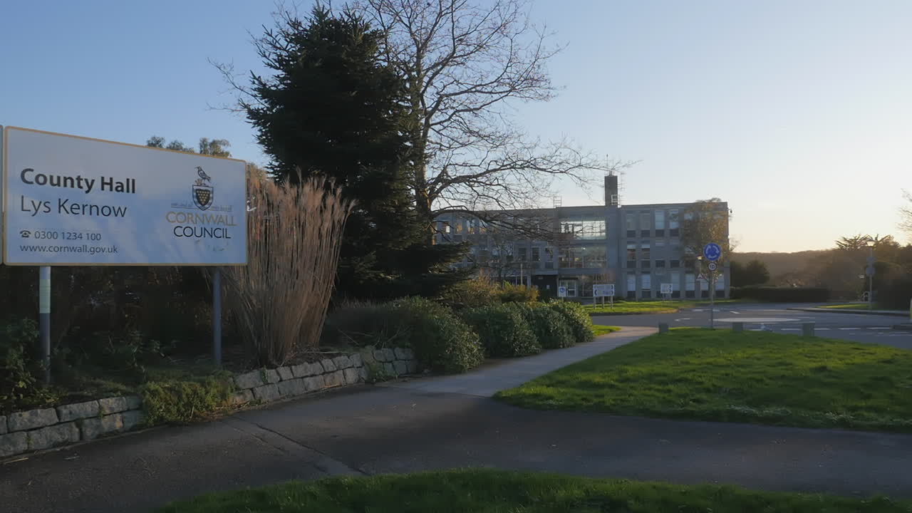 Sunset over the beautiful landscaping of the county hall of Truro, Cornwall - wide shot