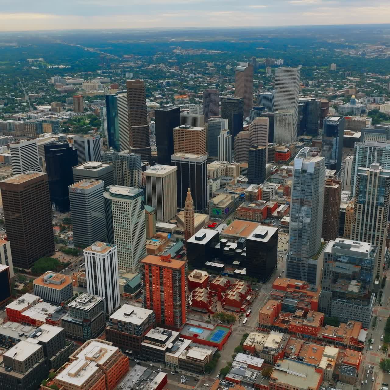 Denver downtown with beautiful skyscrapers. Modern urban panorama of low houses with lots of greenery. Aerial view