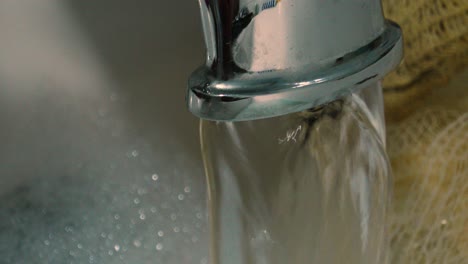 slow motion close up of bath tap filling up bathtub with hot water to clean body for good hygiene and cleanliness.