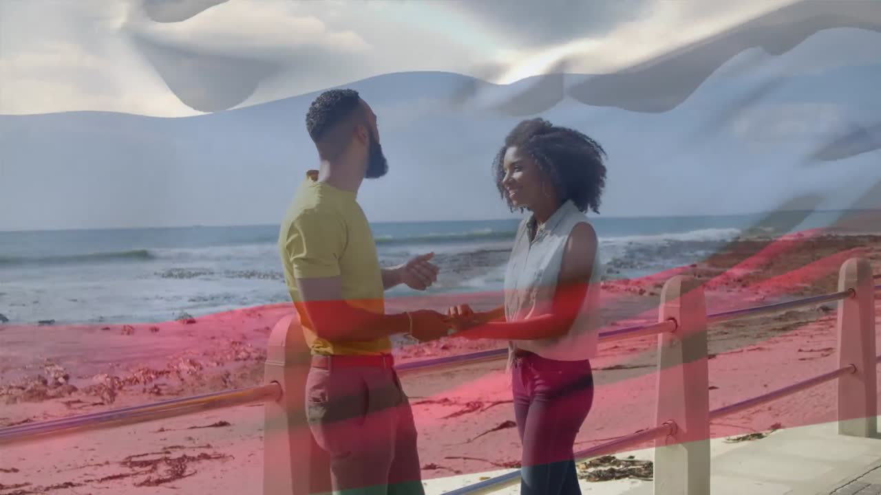 animación de la bandera de rusia sobre una pareja afroamericana en la playa