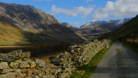 a camera track across a wall and road in the beautiful nant ffrancon pass in wales in the uk