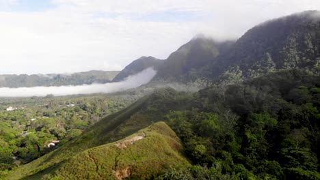 Valle-de-Anton-in-central-Panama-located-in-extinct-volcano-crater-passing-low-peaks,-Aerial-wide-close-in-shot