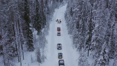 Cars-stuck-on-a-snow-covered-cross-country-road-going-through-Lapland-during-midwinter-solstice