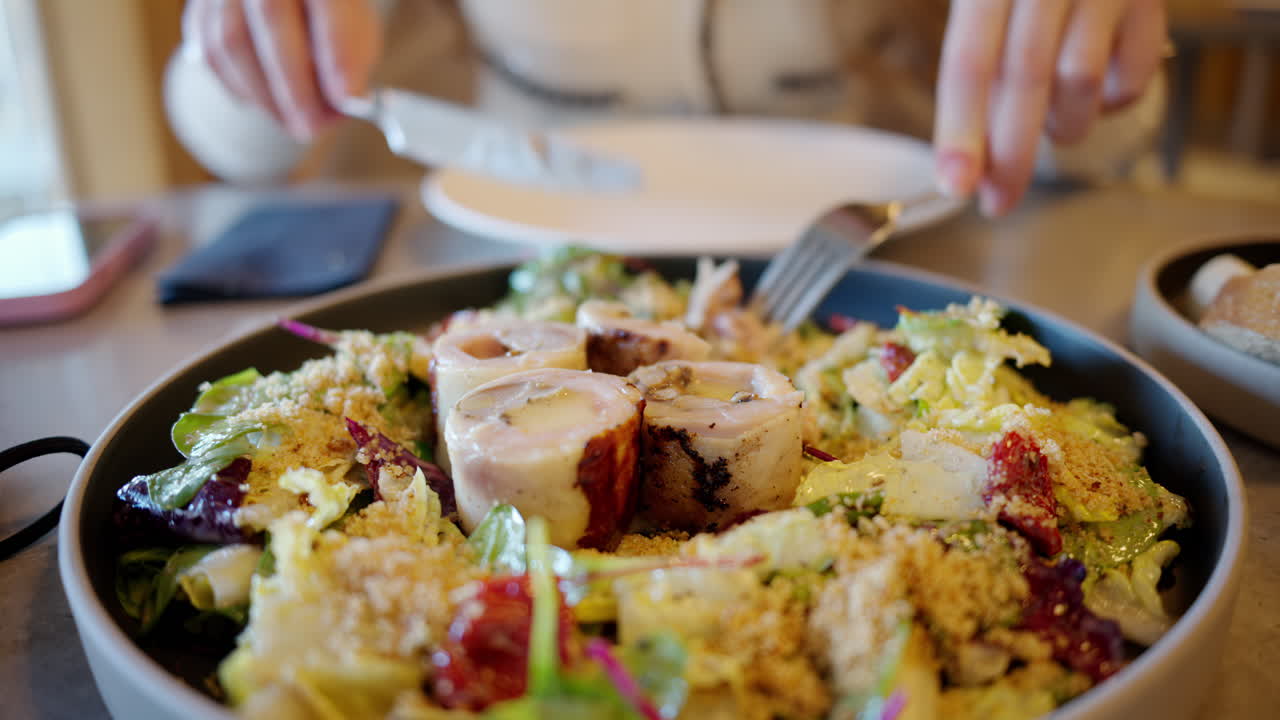 Woman eating a salad at a restaurant