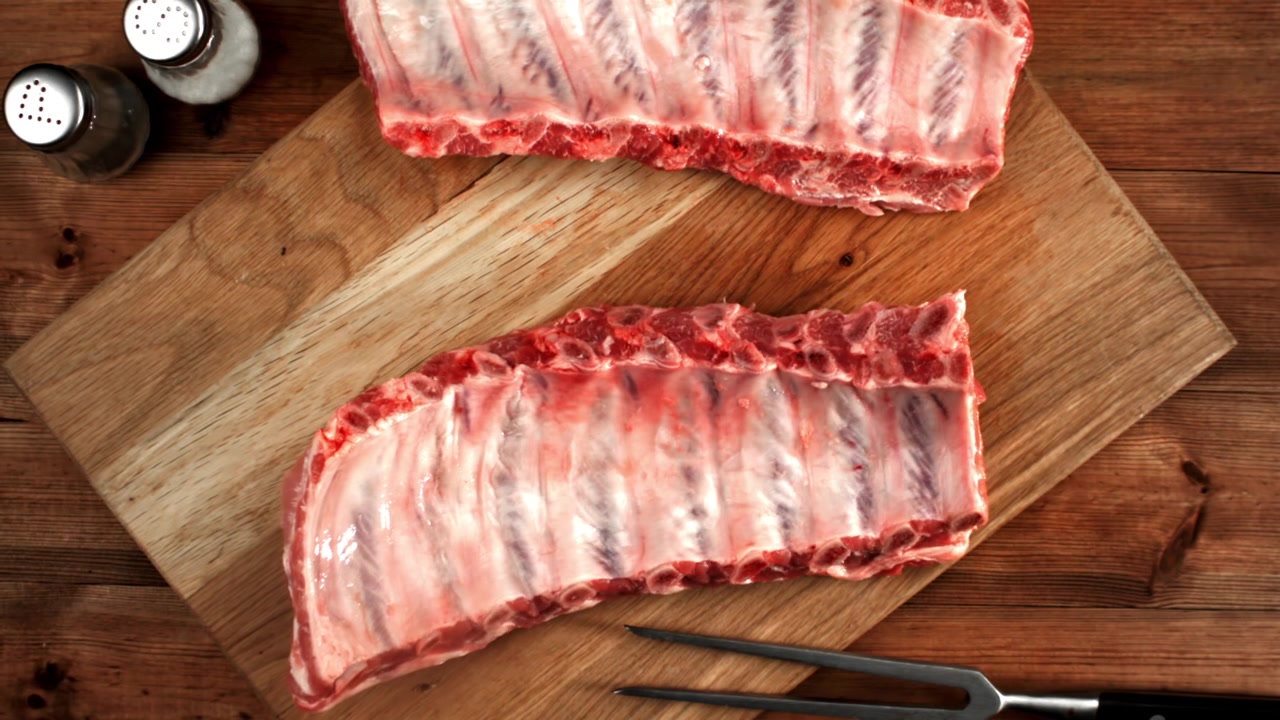 Raw Pork Ribs on a Wooden Cutting Board with Spices