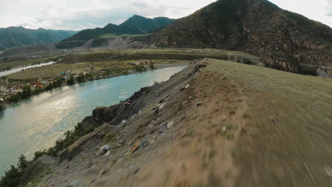 undulating tracks ribbon across mountain spine. descending in river valley offers unbridled experience of highlands. beckoning adventurers to embark