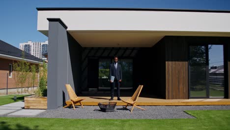 real estate agent in front of modern home