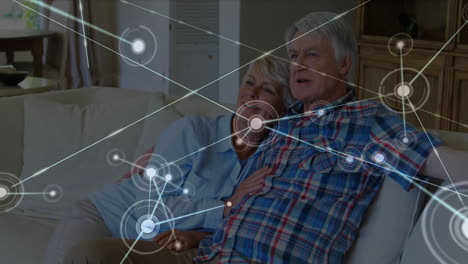 animation of network of connections over senior caucasian couple